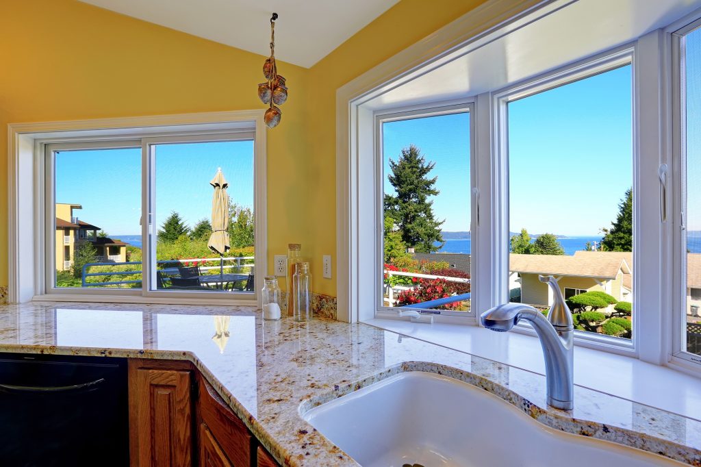 Kitchen With Granite Tops And Beautiful Window View Glass